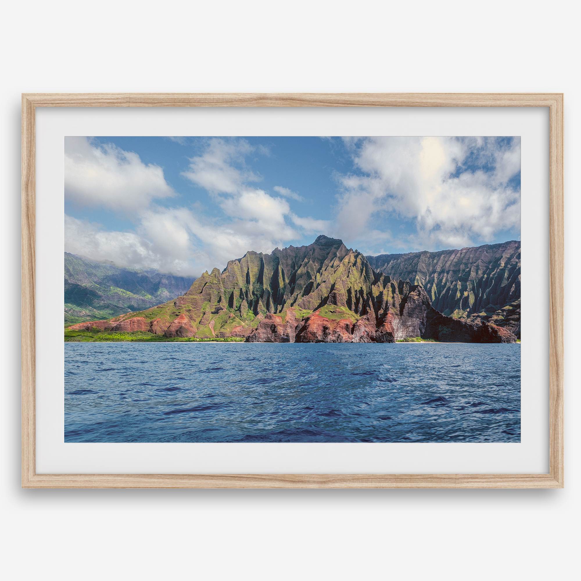 An extra large wall art showcasing the vertical green volcanic cliffs of Na Pali Coast Kauai meeting the blue Pacific Ocean.
