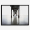 La Jolla coastal photograph looking beneath Scripps Pier toward the Pacific horizon, featuring symmetrical columns and minimalist ocean tones.