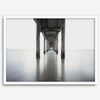 La Jolla coastal photograph looking beneath Scripps Pier toward the Pacific horizon, featuring symmetrical columns and minimalist ocean tones.