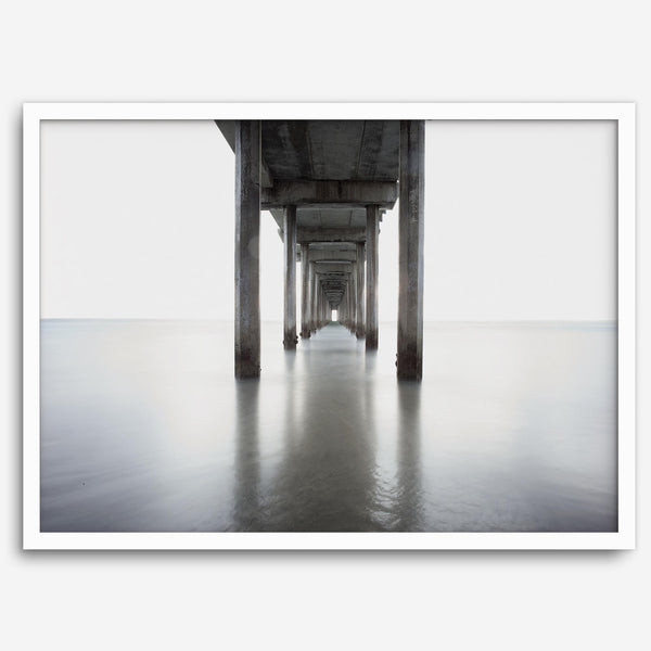 La Jolla coastal photograph looking beneath Scripps Pier toward the Pacific horizon, featuring symmetrical columns and minimalist ocean tones.