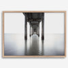 La Jolla coastal photograph looking beneath Scripps Pier toward the Pacific horizon, featuring symmetrical columns and minimalist ocean tones.