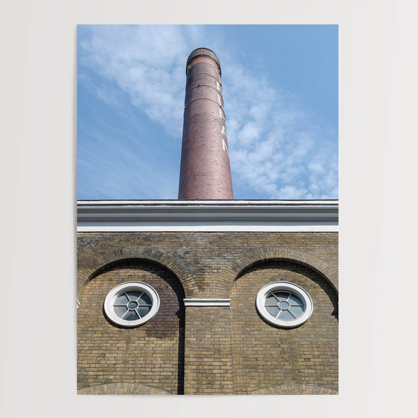 Vertical photography of the Old Truman Brewery chimney in Shoreditch with windows resembling eyes.