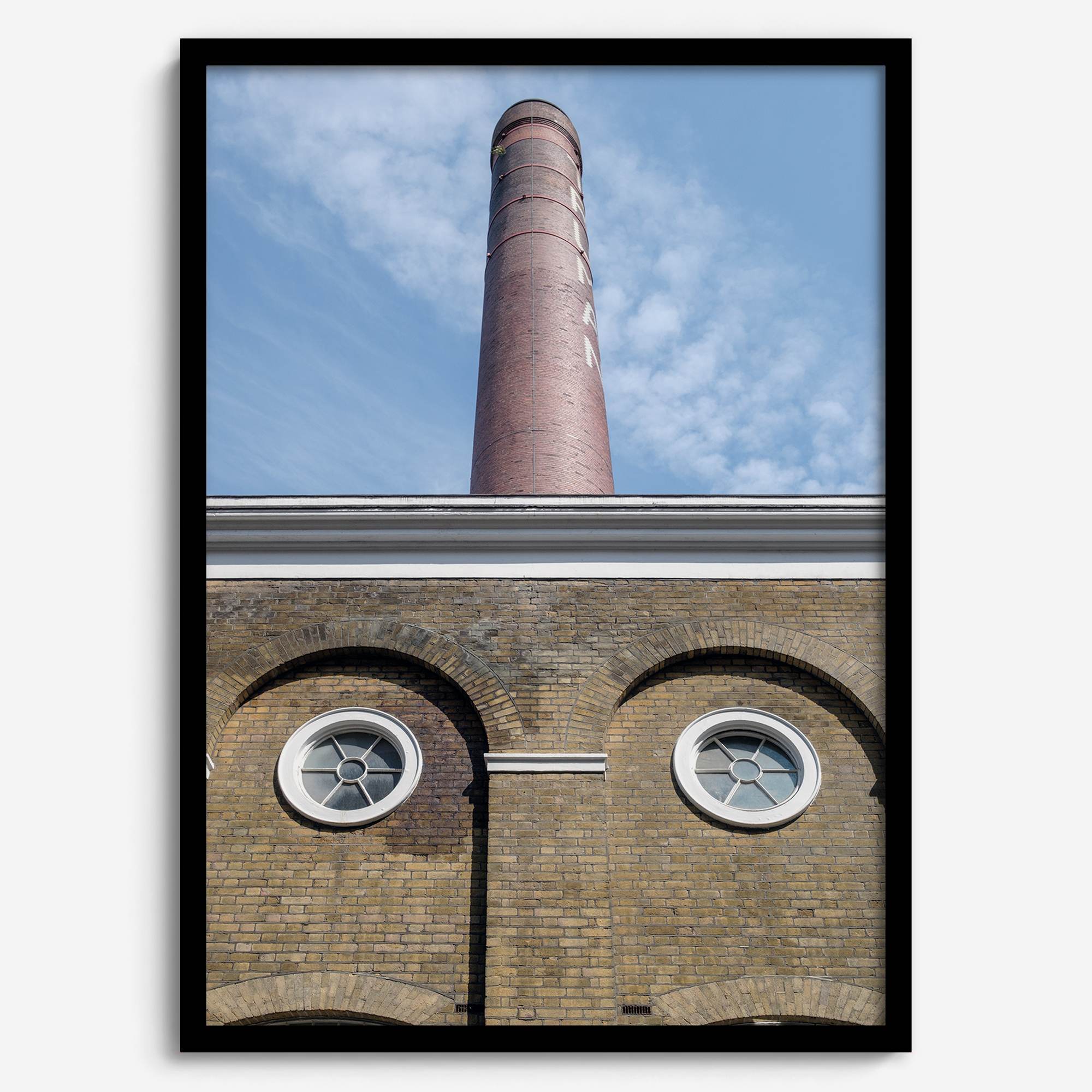 Vertical photography of the Old Truman Brewery chimney in Shoreditch with windows resembling eyes.