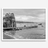 Scenic Pacific Northwest wall art of Trinidad State Park in California in black and white, showcasing a coastal pier, lush green cliffs, and calm ocean waves under cloudy skies.