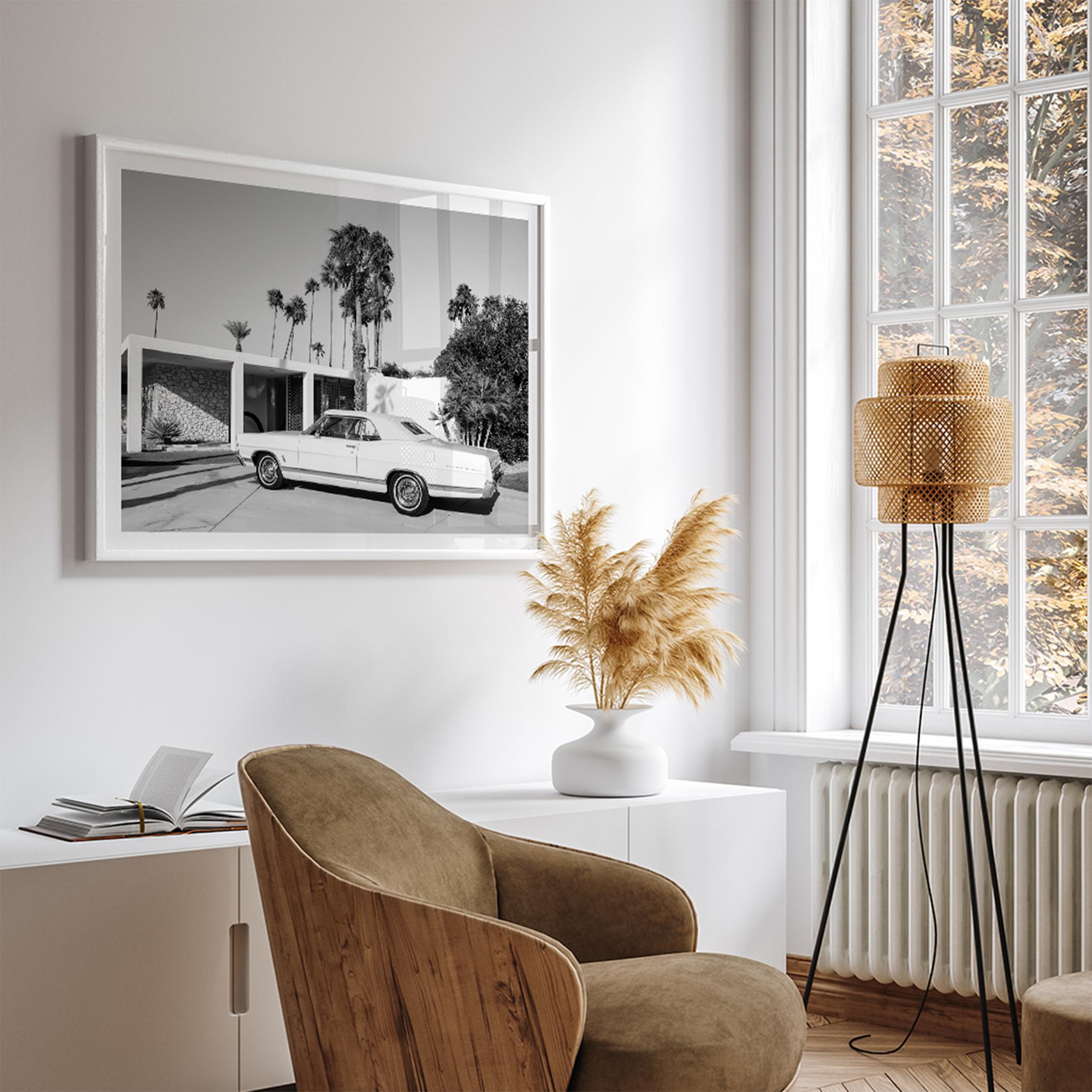 Palm Springs artwork featuring a classic vintage car, mid-century modern architecture and tall desert palm trees in black and white.