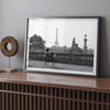 Black-and-white Paris wall art featuring a woman reading in a park with the Eiffel Tower in the background.
