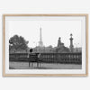 Black-and-white Paris wall art featuring a woman reading in a park with the Eiffel Tower in the background.