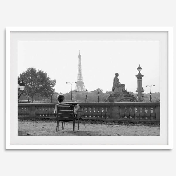 Black-and-white Paris wall art featuring a woman reading in a park with the Eiffel Tower in the background.