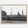 Black-and-white Paris wall art featuring a woman reading in a park with the Eiffel Tower in the background.