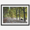 A fine art Paris print of Jardin des Tuileries in fall, featuring a couple sitting on a bench beneath vibrant autumn trees, surrounded by golden foliage.