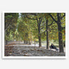 A fine art Paris print of Jardin des Tuileries in fall, featuring a couple sitting on a bench beneath vibrant autumn trees, surrounded by golden foliage.