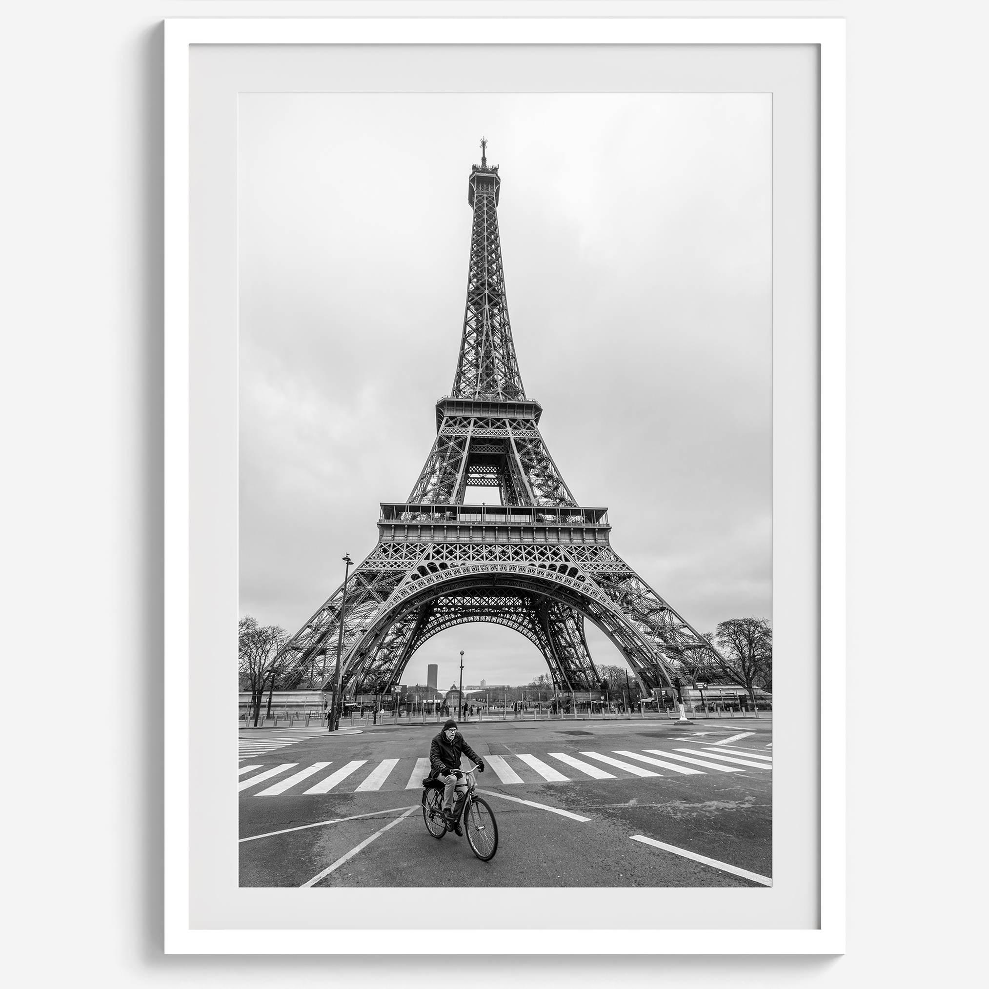 Black-and-white Eiffel Tower photo with a cyclist in the foreground, perfect for Paris wall art decor.