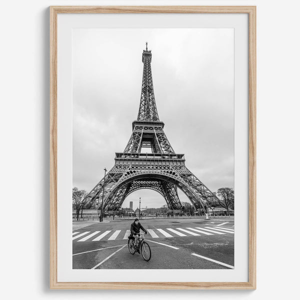 Black-and-white Eiffel Tower photo with a cyclist in the foreground, perfect for Paris wall art decor.