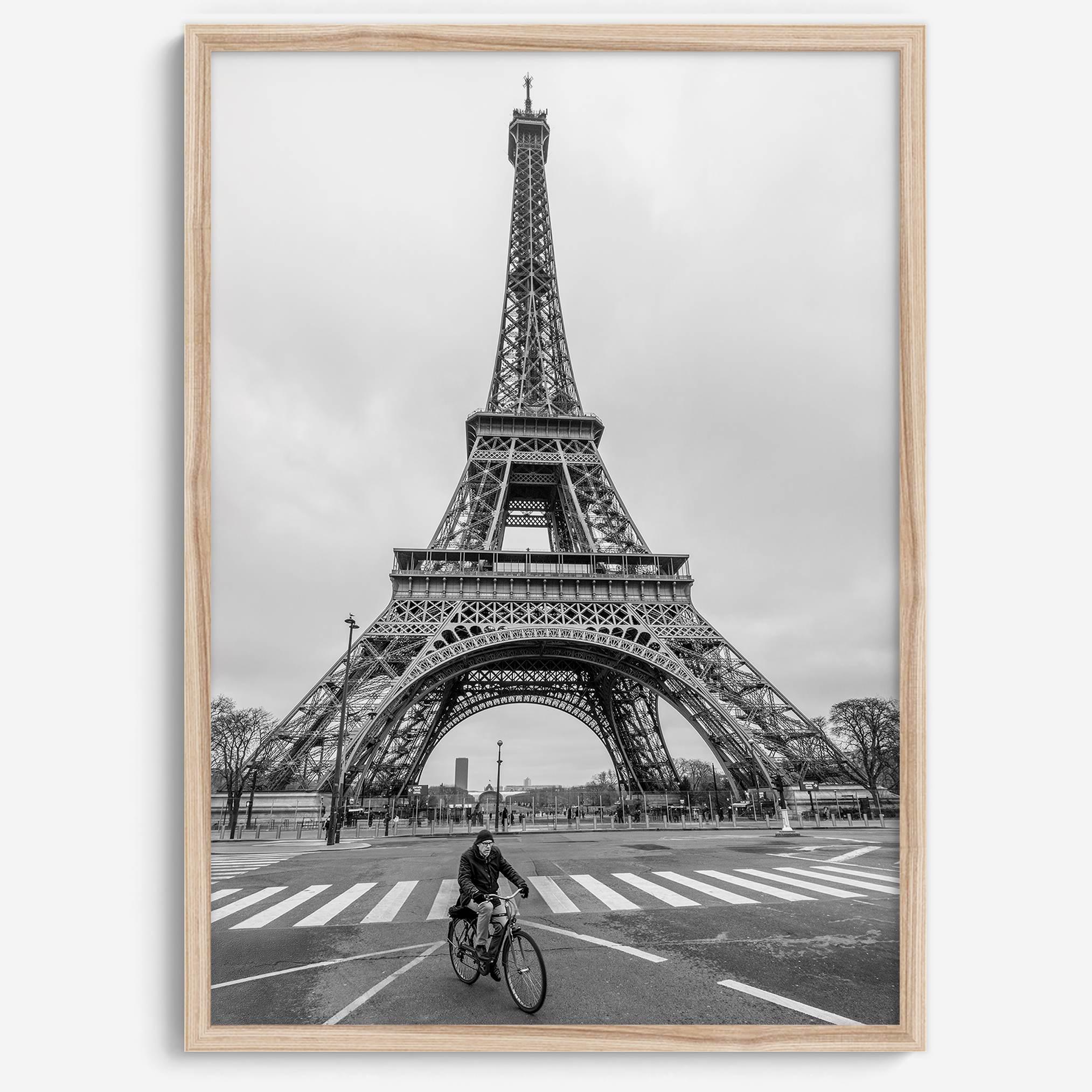 Black-and-white Eiffel Tower photo with a cyclist in the foreground, perfect for Paris wall art decor.