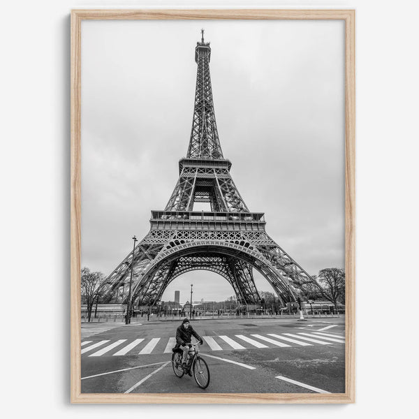 Black-and-white Eiffel Tower photo with a cyclist in the foreground, perfect for Paris wall art decor.