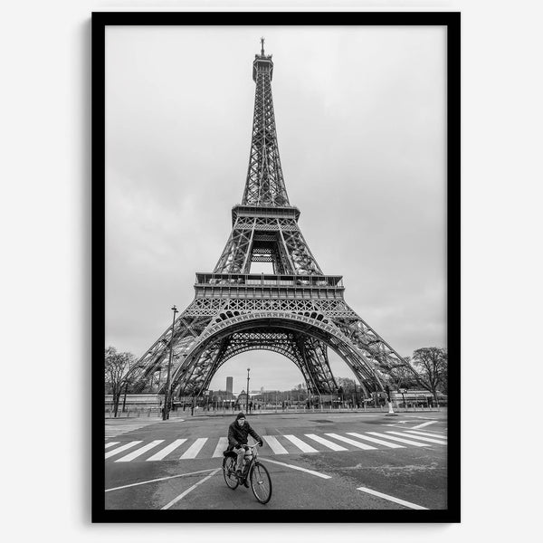 Black-and-white Eiffel Tower photo with a cyclist in the foreground, perfect for Paris wall art decor.