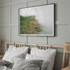 Minimalist nature artwork of coastal grasses leaning towards calm water on a misty day