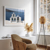 Santorini wall art featuring white church bell towers above the Aegean Sea in Santorini, Greece with volcanic cliffs and sailboats.
