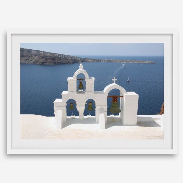 Santorini wall art featuring white church bell towers above the Aegean Sea in Santorini, Greece with volcanic cliffs and sailboats.