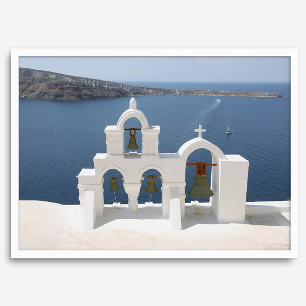Santorini wall art featuring white church bell towers above the Aegean Sea in Santorini, Greece with volcanic cliffs and sailboats.