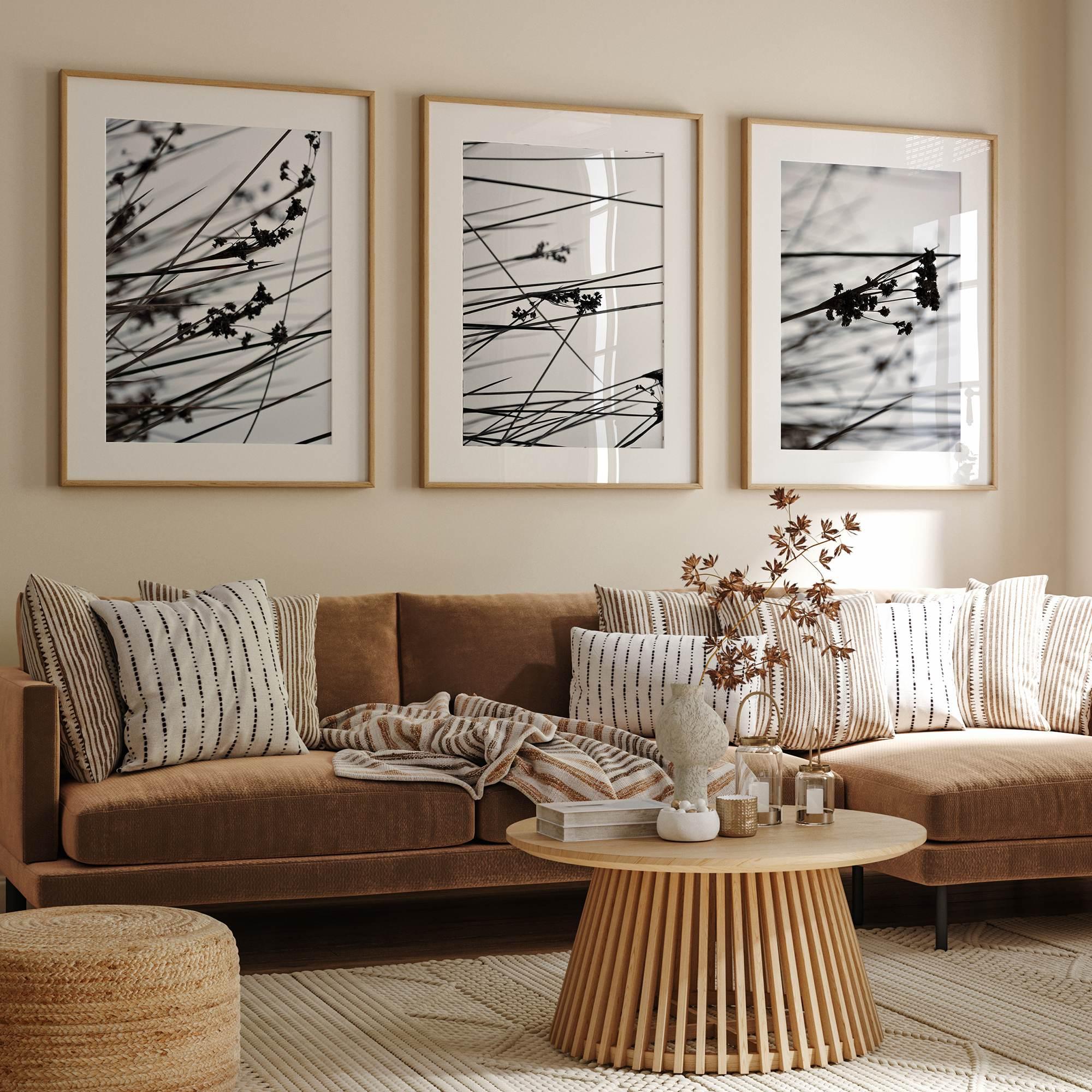 Minimalist black and white floral triptych with abstract plant silhouettes and delicate botanical linework.