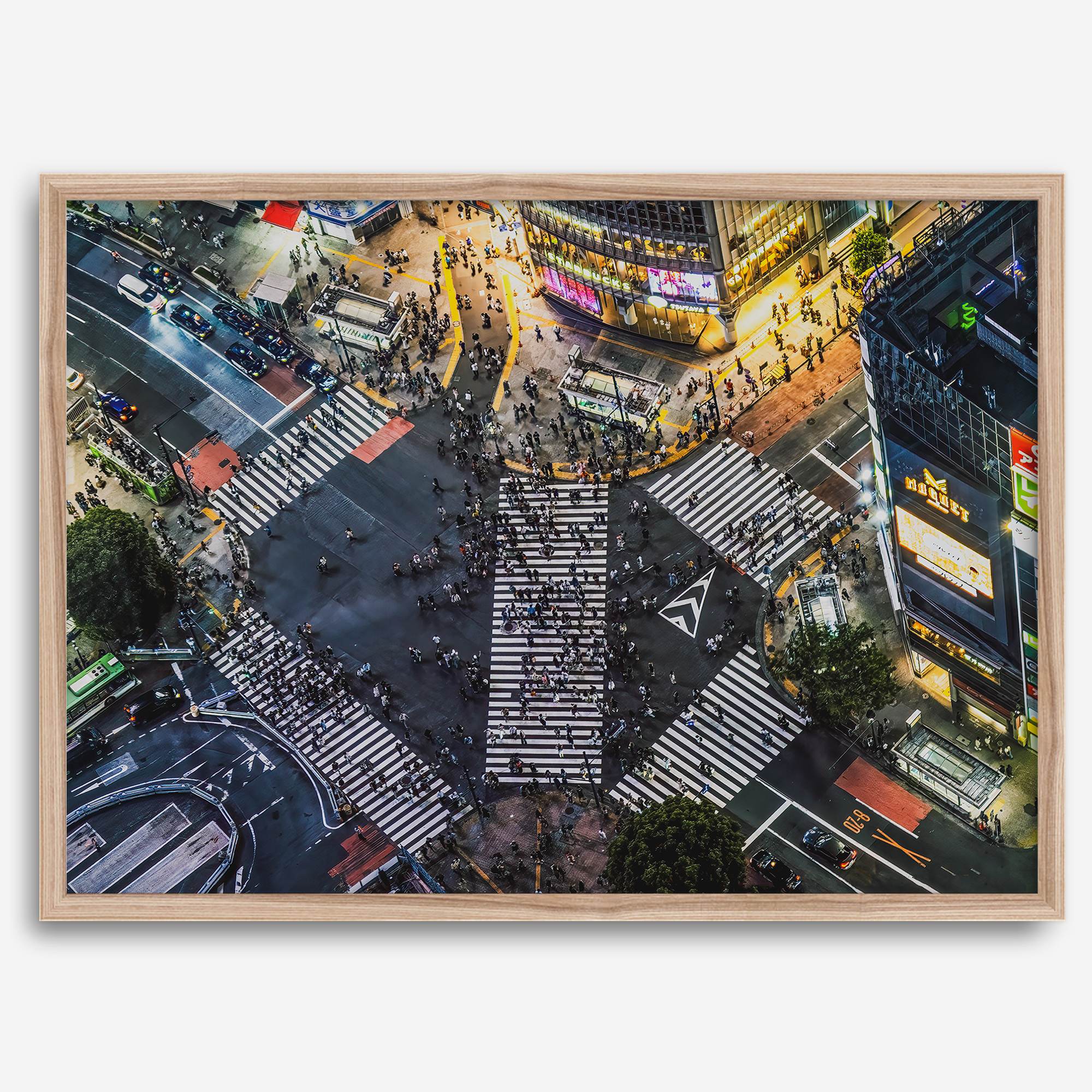 Shibuya Crossing print featuring an aerial Tokyo night scene with illuminated crosswalks and vibrant urban movement.
