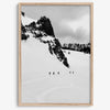 A fine art print showing five skiers traversing a vast, snowy mountain landscape under a pale winter sky, surrounded by untouched wilderness.