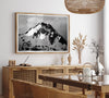 Black and white fine art photograph of a snowy Alaska mountain rising above coastal waters beneath dramatic clouds.