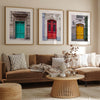 Colorful three piece wall art featuring bold architectural doors in red, teal, and yellow tones.