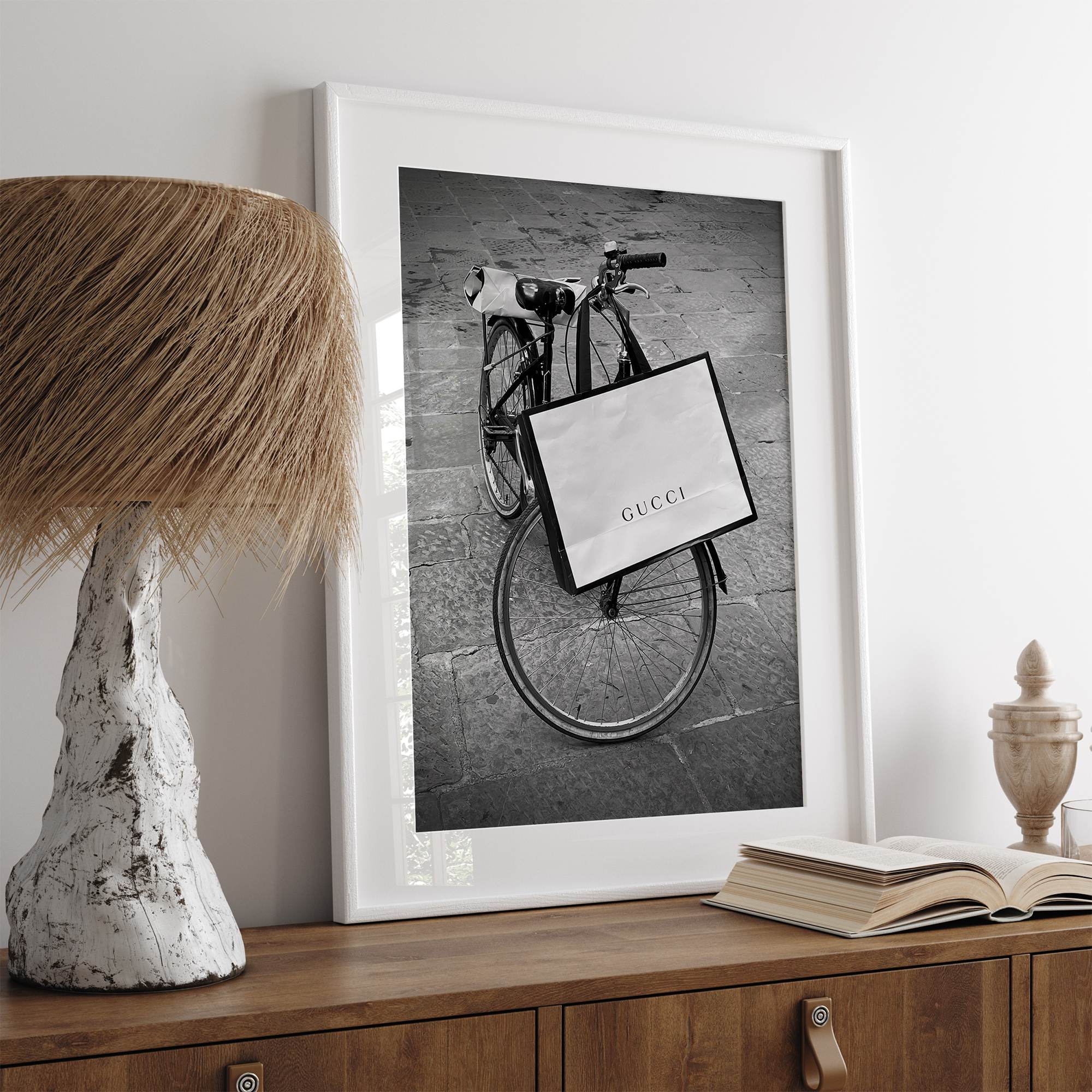 Black and white Florence street photography featuring a vintage bicycle and designer shopping bag near Via della Vigna Nuova