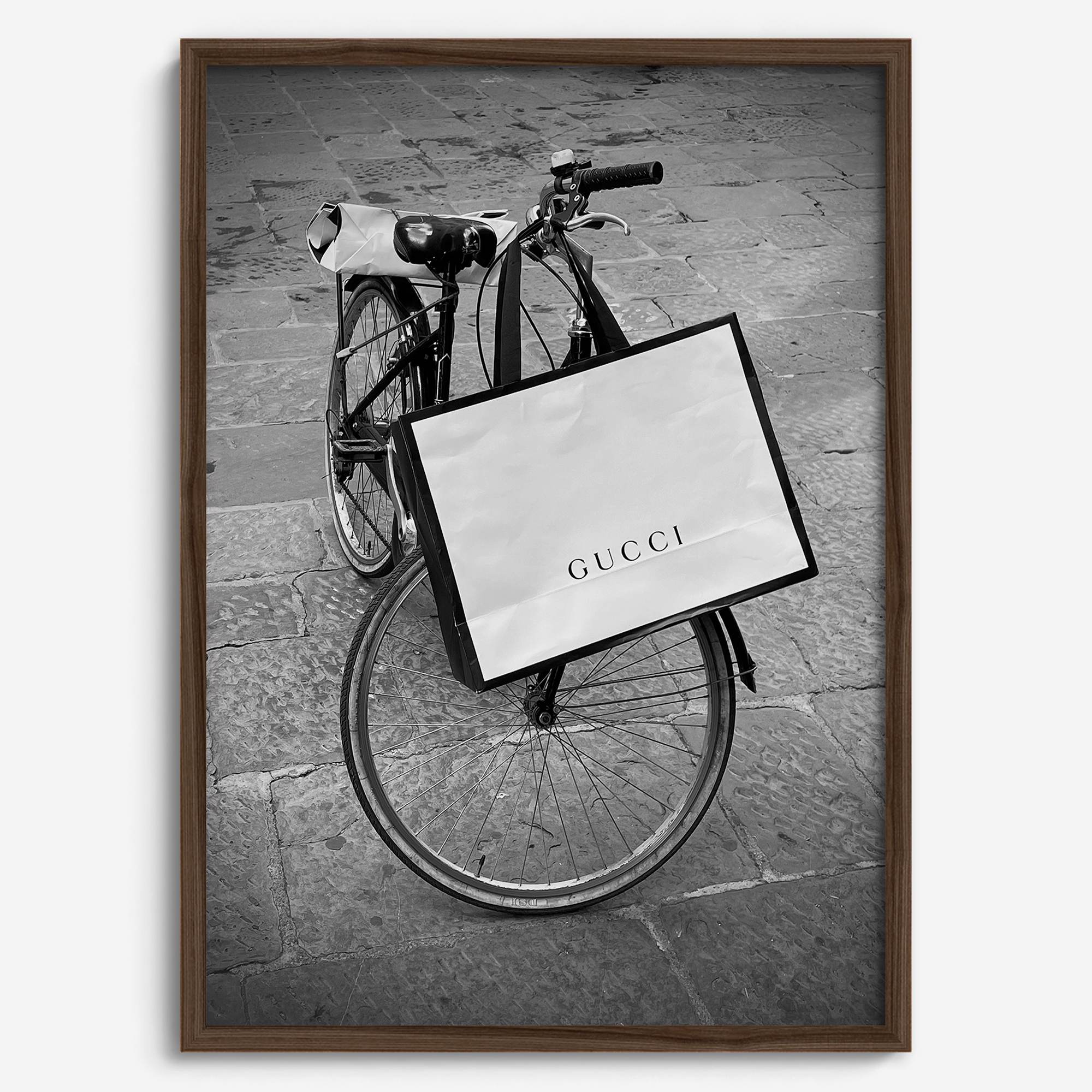 Black and white Florence street photography featuring a vintage bicycle and designer shopping bag near Via della Vigna Nuova
