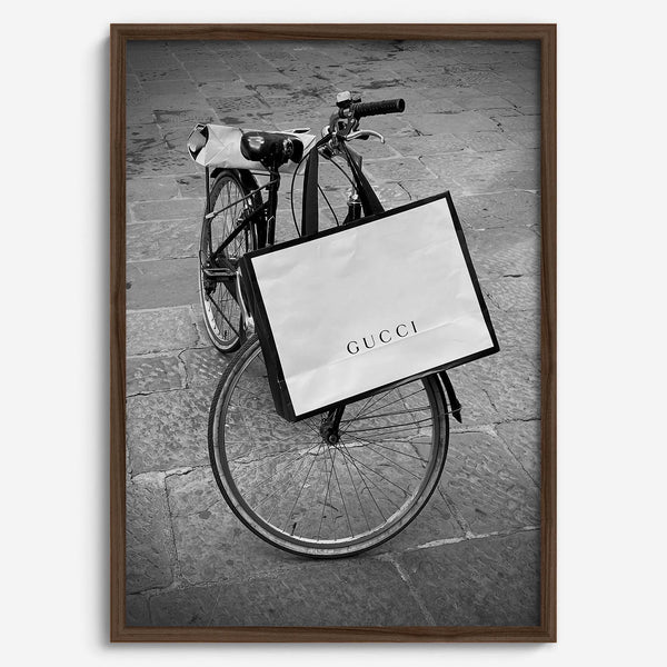 Black and white Florence street photography featuring a vintage bicycle and designer shopping bag near Via della Vigna Nuova
