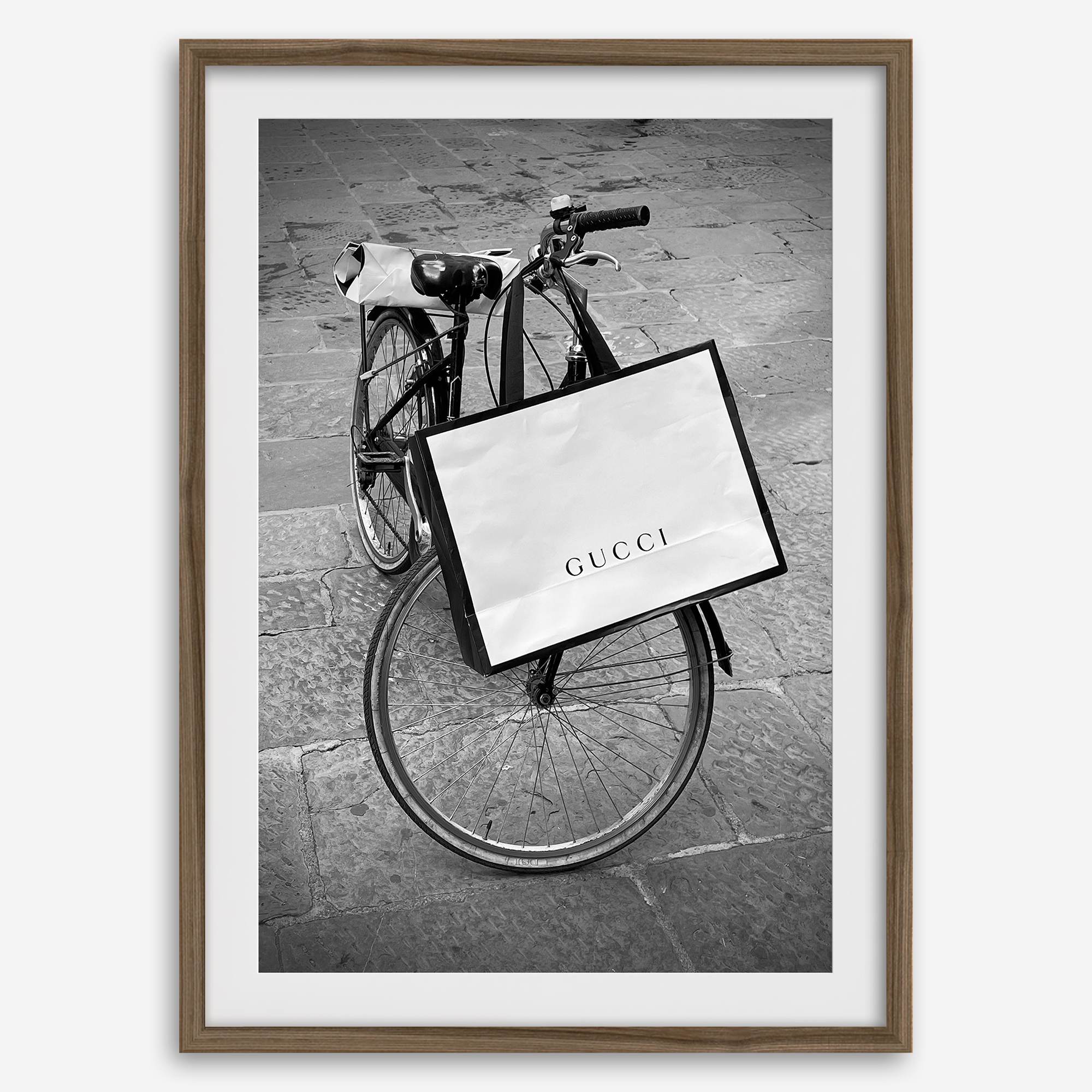 Black and white Florence street photography featuring a vintage bicycle and designer shopping bag near Via della Vigna Nuova