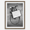 Black and white Florence street photography featuring a vintage bicycle and designer shopping bag near Via della Vigna Nuova