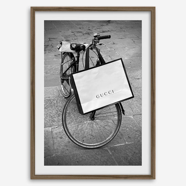 Black and white Florence street photography featuring a vintage bicycle and designer shopping bag near Via della Vigna Nuova