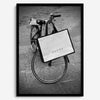 Black and white Florence street photography featuring a vintage bicycle and designer shopping bag near Via della Vigna Nuova