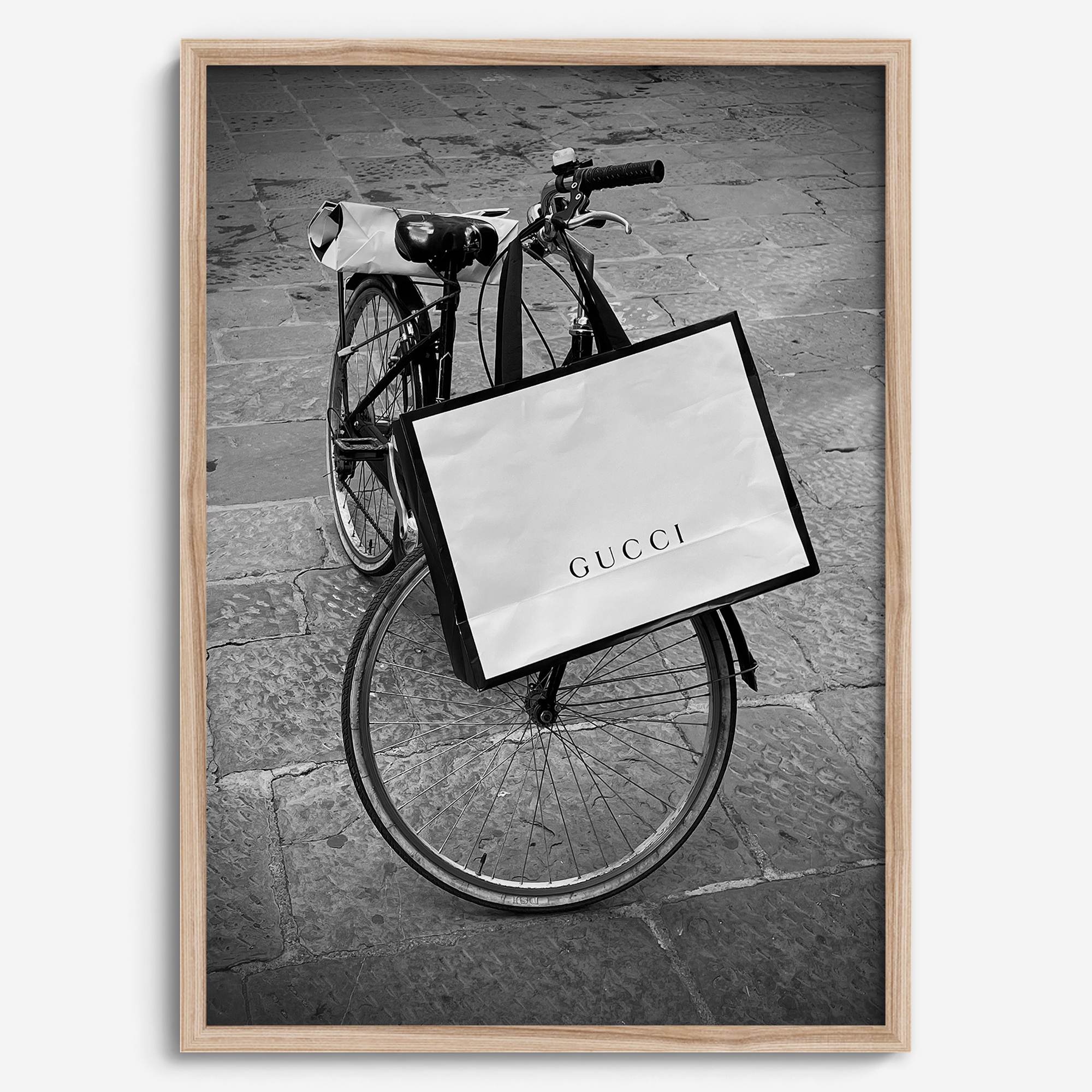 Black and white Florence street photography featuring a vintage bicycle and designer shopping bag near Via della Vigna Nuova