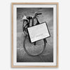 Black and white Florence street photography featuring a vintage bicycle and designer shopping bag near Via della Vigna Nuova