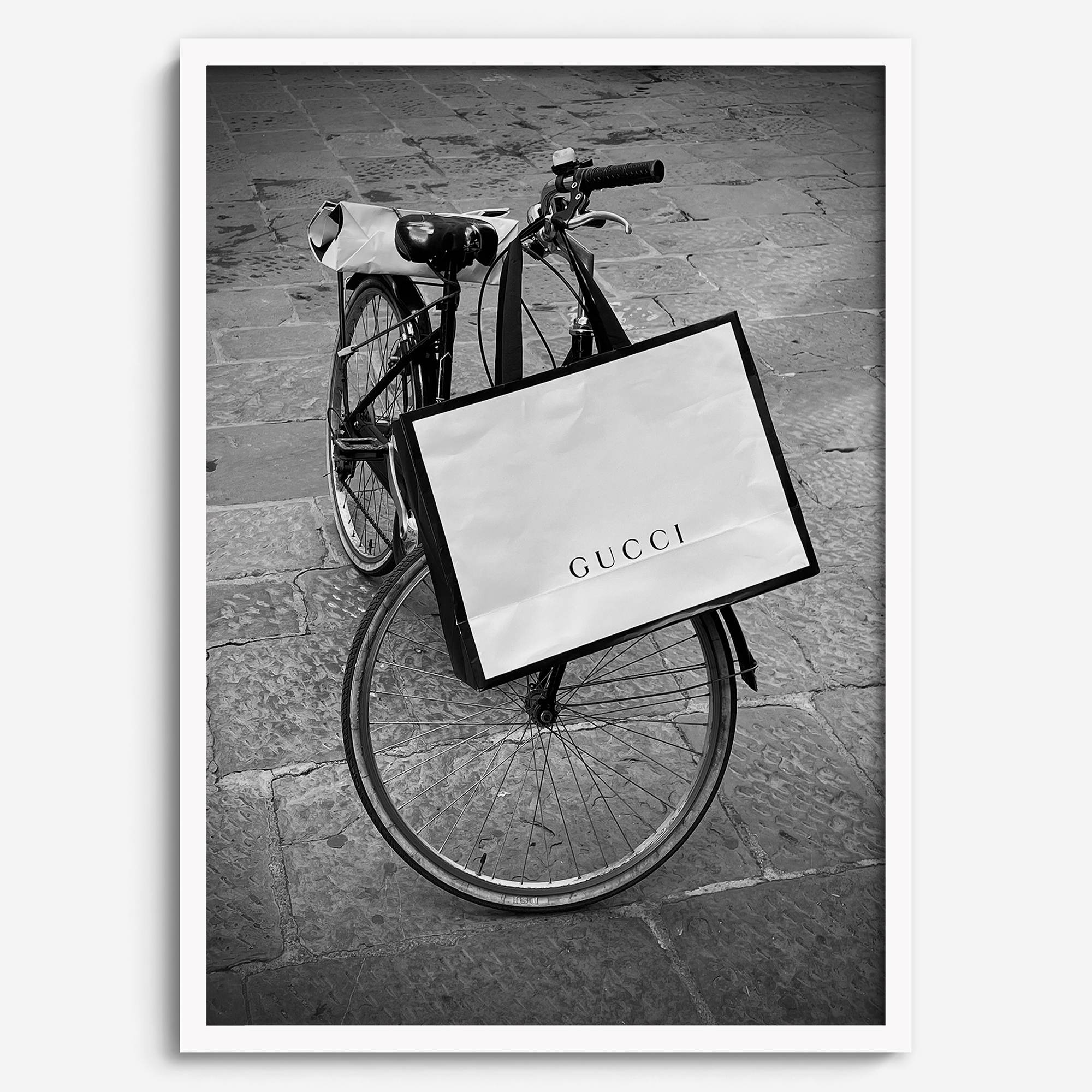 Black and white Florence street photography featuring a vintage bicycle and designer shopping bag near Via della Vigna Nuova