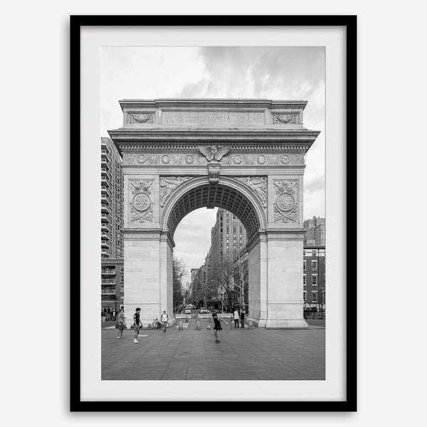 A Black and white architectural photograph print of Washington Square Arch in Greenwich Village, New York City, with people playing soccer in the foreground.