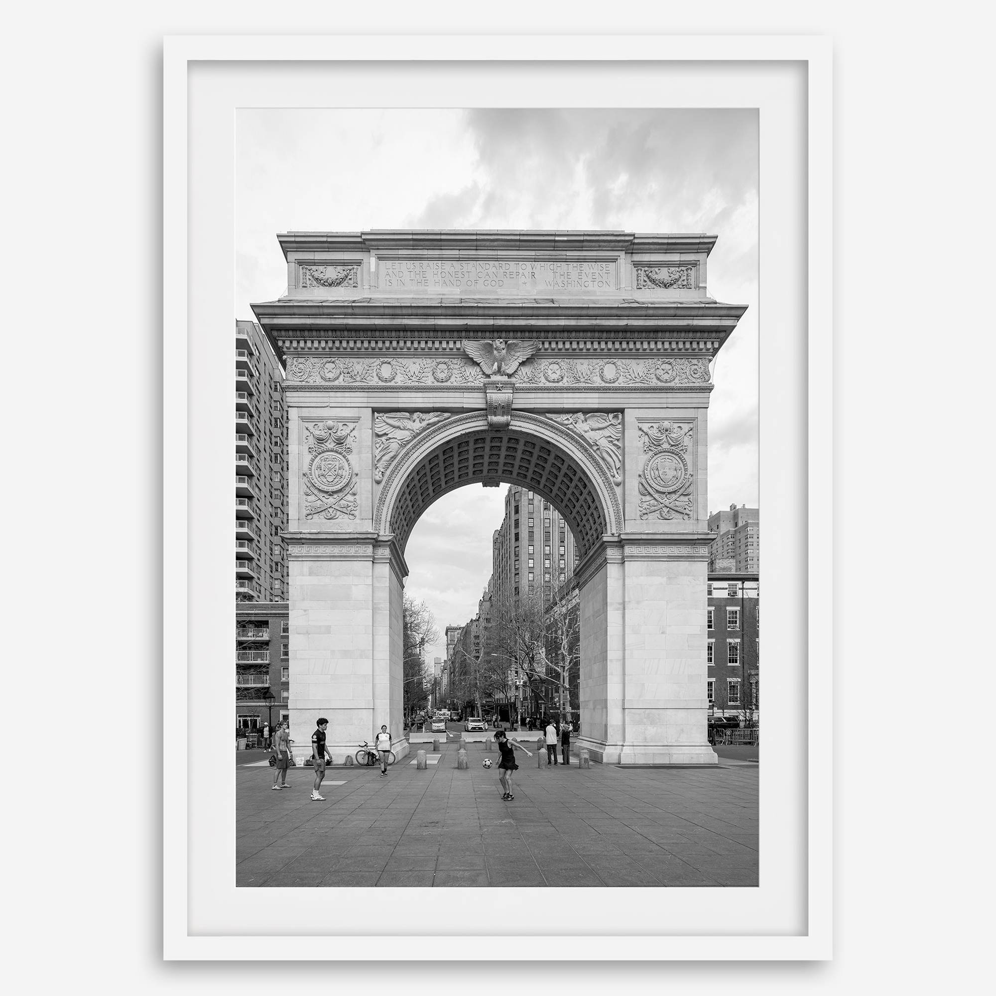 A Black and white architectural photograph print of Washington Square Arch in Greenwich Village, New York City, with people playing soccer in the foreground.