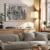 Black and white zebra wall art showing a herd of zebras with overlapping striped patterns, presented in a black frame with a white mat.