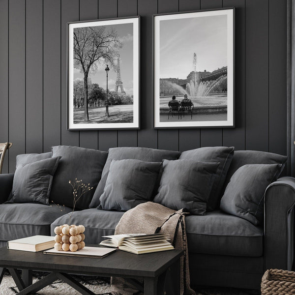 A wall art set of 2 prints from Paris. Left print - Eiffel Tower from Jardin de la Tour Eiffel. Right print - couple sitting in front of the fountain in Palais Royal Garden.