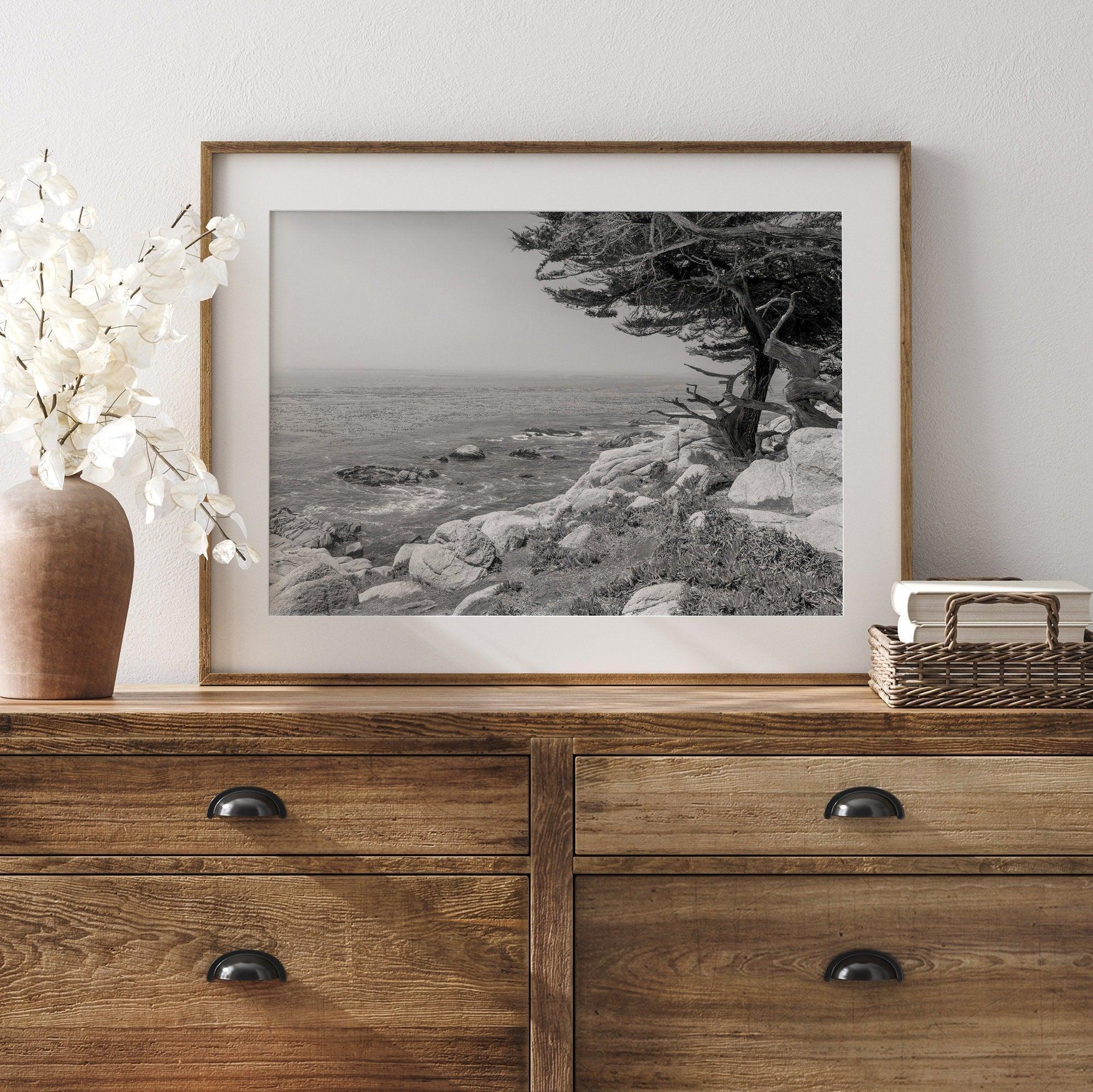 Black and white coastal art featuring Pebble Beach’s rocky shoreline and ocean view.