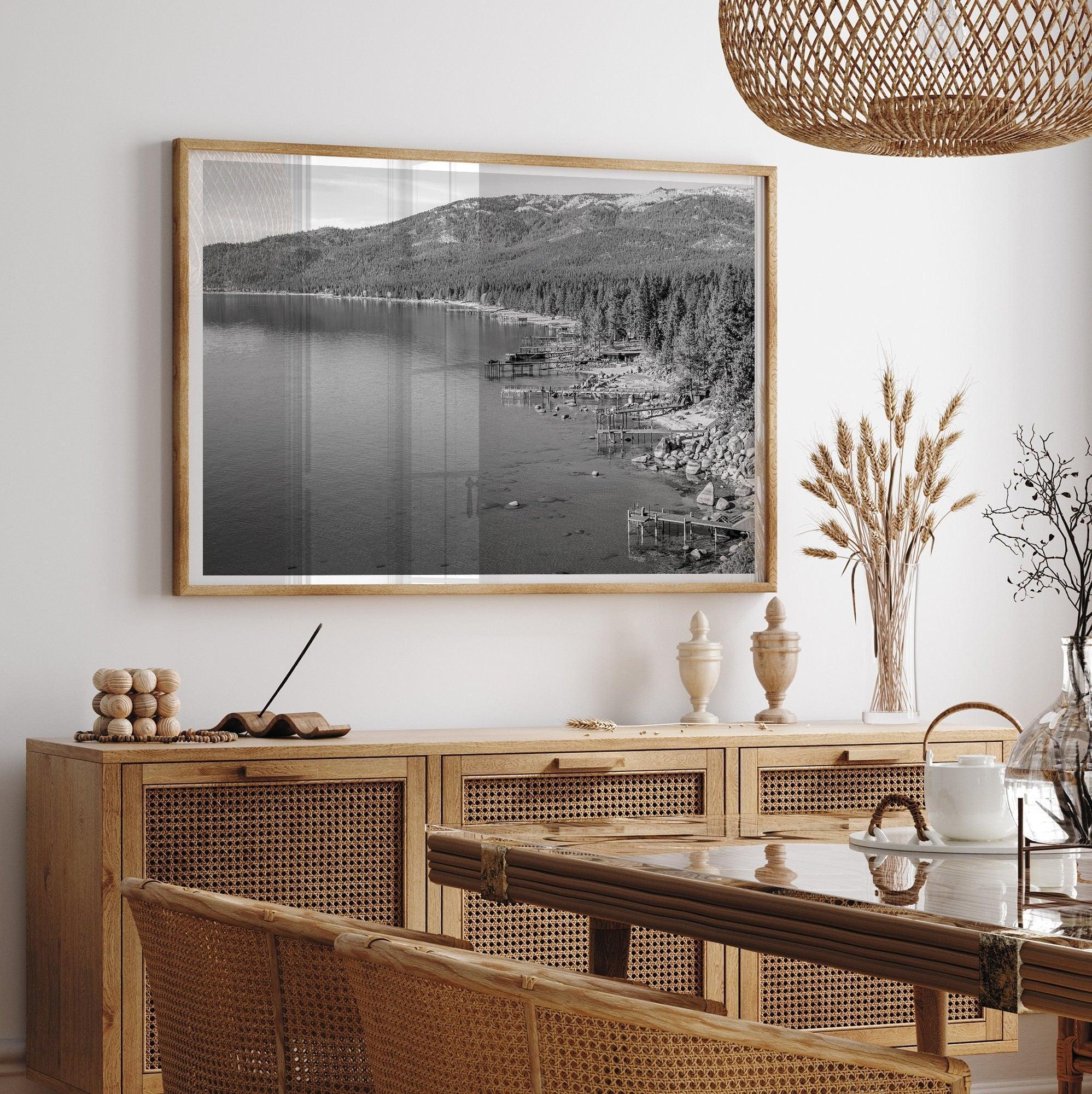 Tahoe Lake LifeA fine art black and white Lake Tahoe print showcasing docks and boats nested on the lake waters on the left, while the beachfront, nestled against a backdrop of a lush forest and majestic mountain, paints a picturesque scene on the right.