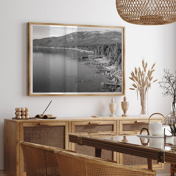 Tahoe Lake LifeA fine art black and white Lake Tahoe print showcasing docks and boats nested on the lake waters on the left, while the beachfront, nestled against a backdrop of a lush forest and majestic mountain, paints a picturesque scene on the right.