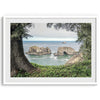 This stunning coastal photo was taken in Samuel H. Boardman State Scenic Corridor in Oregon. This ocean wall art shows unique rock formations in a vast blue Pacific Ocean through a window created from coastal trees and plants.