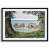 This stunning coastal photo was taken in Samuel H. Boardman State Scenic Corridor in Oregon. This ocean wall art shows unique rock formations in a vast blue Pacific Ocean through a window created from coastal trees and plants.