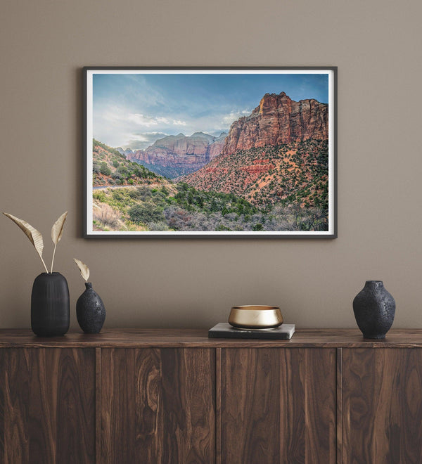 A fine art desert print from Zion National Park showcasing a stunning towering cliff and winding road.