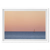 This stunning fine art ocean sunset photography print features a breathtaking scene of a boat against a golden and pink sky at sunset. The warm glow of the sunset and the natural beauty of the ocean and sky combine to create a soothing atmosphere.